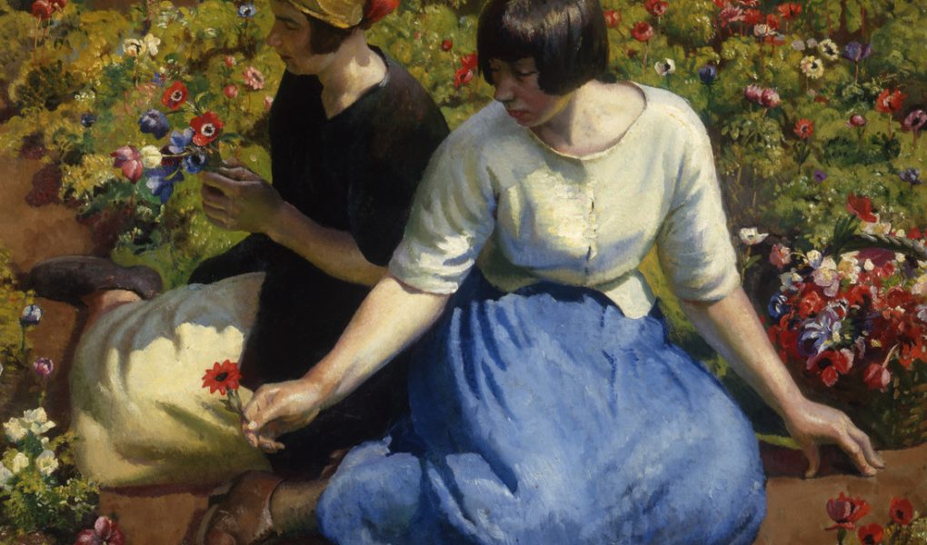 Two women sit in a vibrant flower garden. One wears a light blouse and blue skirt, holding a red flower, and the other wears a dark dress, admiring the blossoms.
