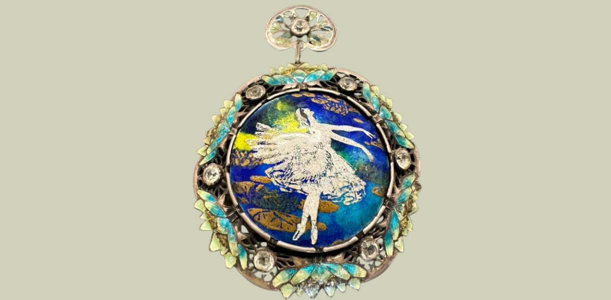 Ornate pendant featuring a ballerina in white on a vibrant blue and green background. Encircled by turquoise and gold floral embellishments.